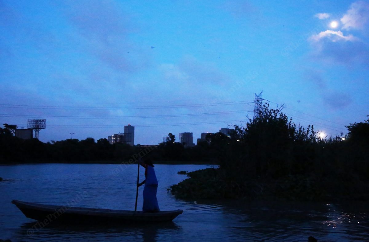 A woman uses the boat to go to the nearest shop to buy groceries | Photo: Manisha Mondal | ThePrint