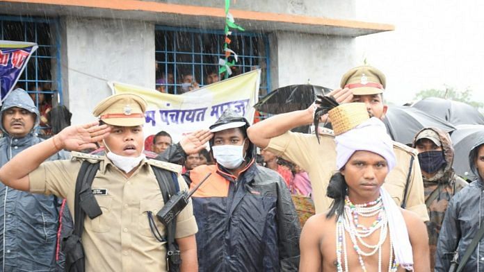 Policemen with a tribal man during an Independence Day ceremony in the Maoist-hit Marjam village in Dantewada district of Bastar, Chhattisgarh | By special arrangement