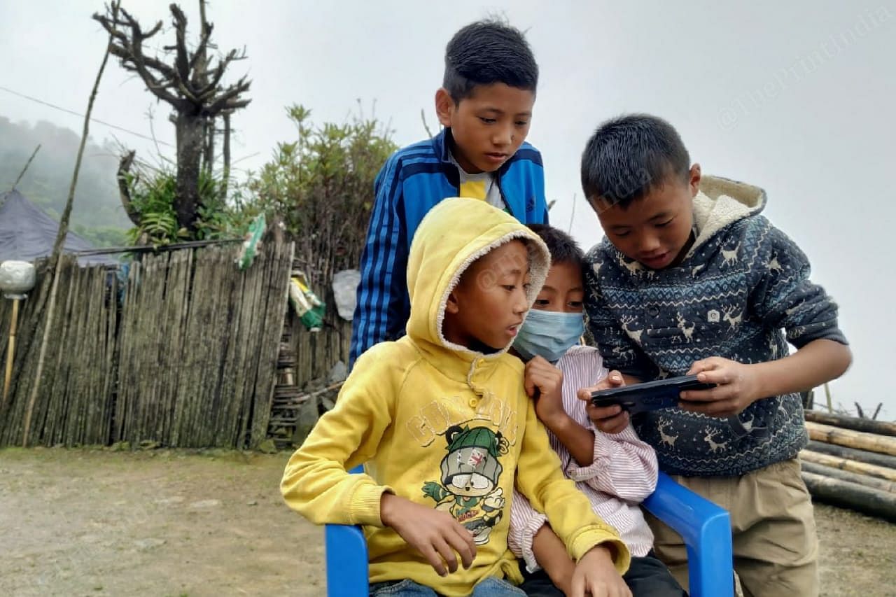 With just 3 smartphones in the entire village, volunteers from the Students Union took turns to use the phone while preparing the kids for their online classes and exams. | Yimkumla Longkumer | ThePrint