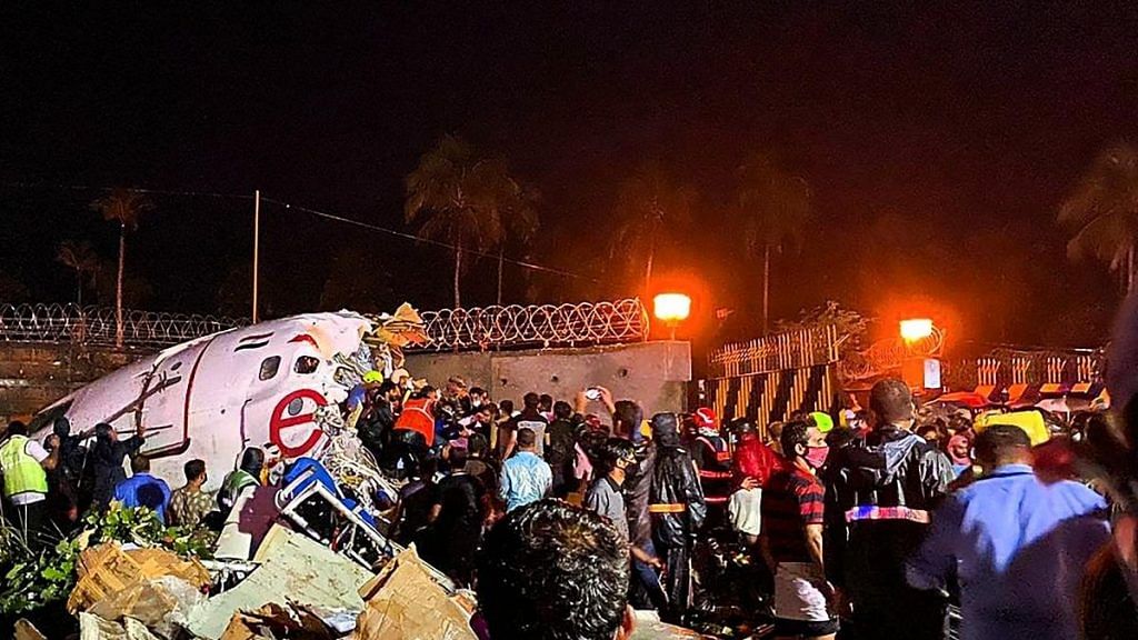 Rescue operation underway after an Air India Express flight with passengers on board en route from Dubai skidded off the runway while landing, at Karippur in Kozhikode | PTI