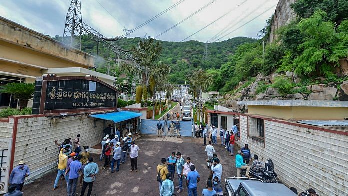 Police and locals outside the Srisailam Left Bank Power Station at Srisailam in Kurnool district on Friday.