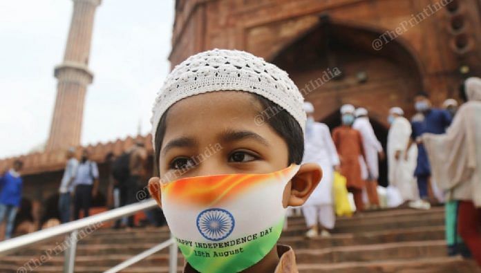 A boy wears a face mask with the Indian flag on it, at Delhi's Jama Masjid | Suraj Singh Bisht | ThePrint