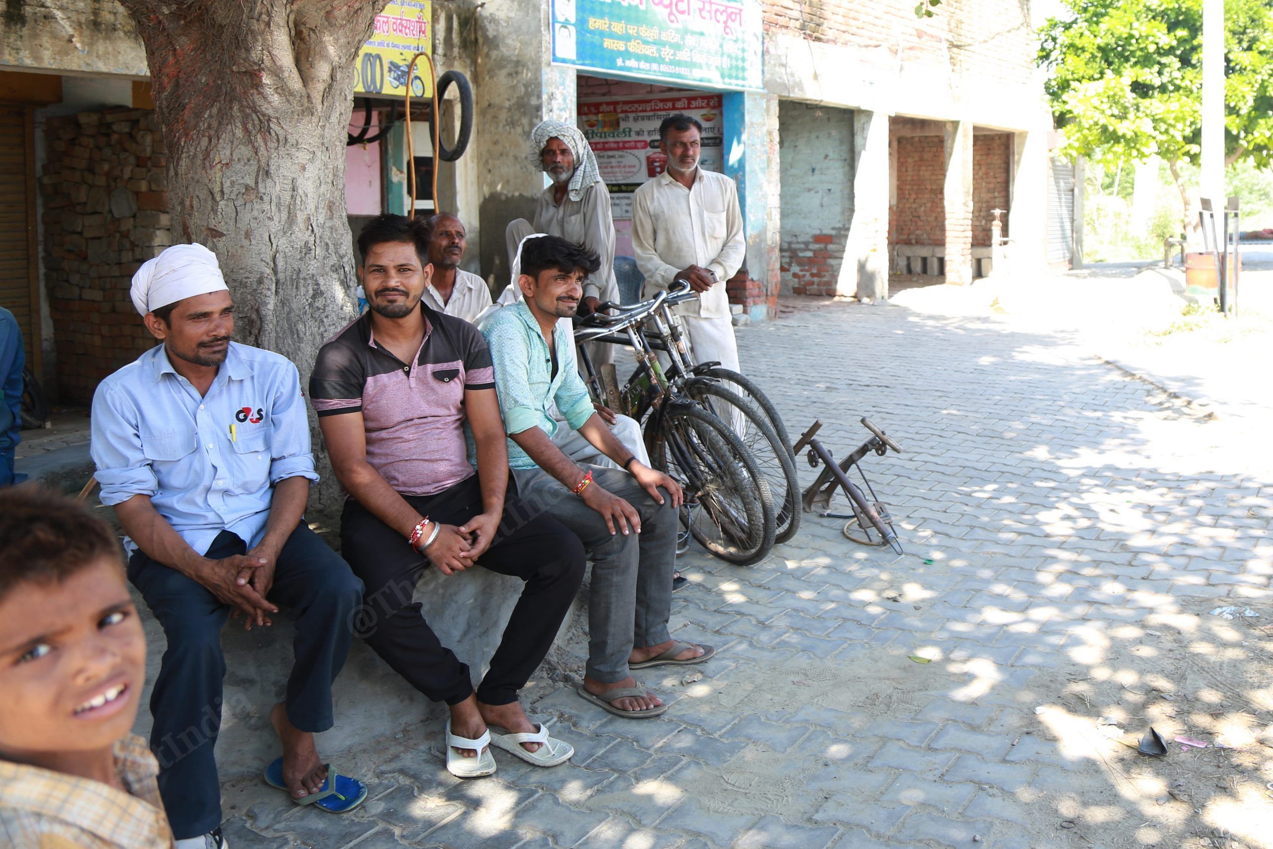 At an intersection in Bal Jattan village, men sit without enforcing physical distancing. | Photo: Manisha Mondal/ThePrint