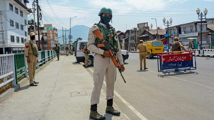 A CRPF jawan stands guard along a street on the first day of the two-day curfew in Srinagar, Tuesday, 4 August, 2020. | PTI