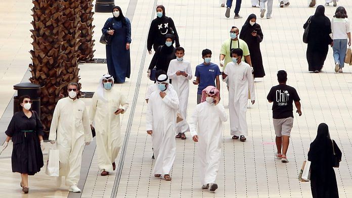 Kuwaitis wearing face masks walk inside the re-opened Avenues Mall, the country's largest shopping centre, on June 30 | Photo: Yasser Al-Zayyat/AFP/Getty Images via Bloomberg