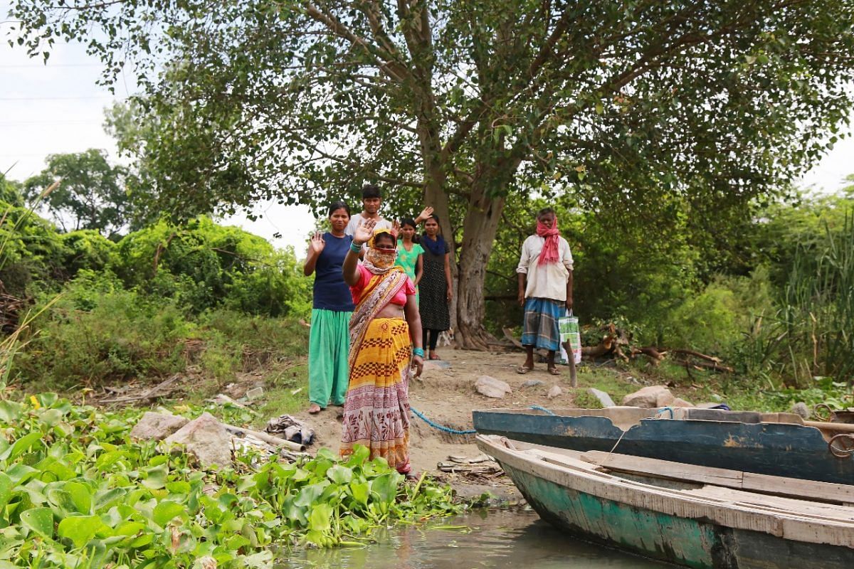 The residents stand at the shore bidding goodbye | Photo: Manisha Mondal | ThePrint