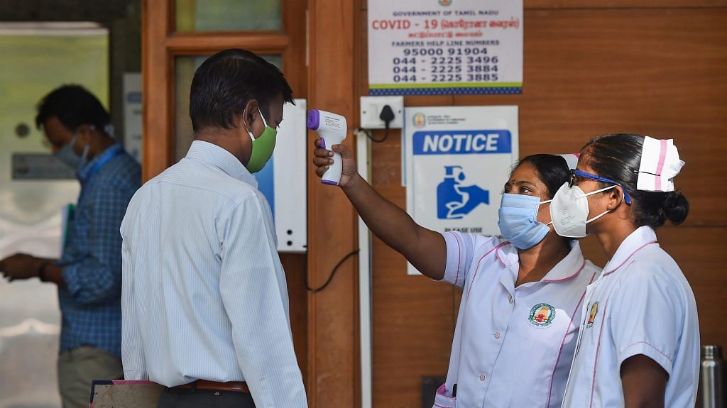 A staff nurse uses a thermal screening device on an employee at a hospital | PTI