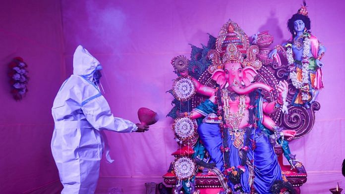 File photo | A devotee wearing a PPE kit offers prayers at a community puja pandal on the occasion of Ganesh Chaturthi, in Kolkata | PTI