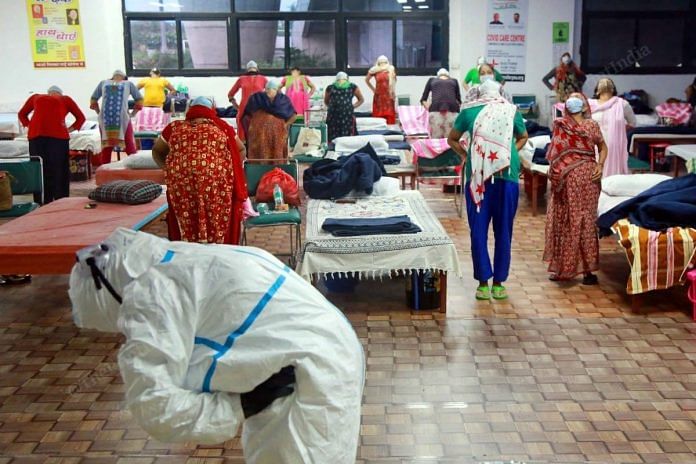 Covid-19 patients practice yoga and exercise at a Covid care facility set up at CWG village, on 22 July 2020 | Manisha Mondal | ThePrint
