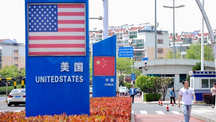Signs with the US flag and Chinese flag are seen at the Qingdao free trade port area in Qingdao in China on 8 May 2019