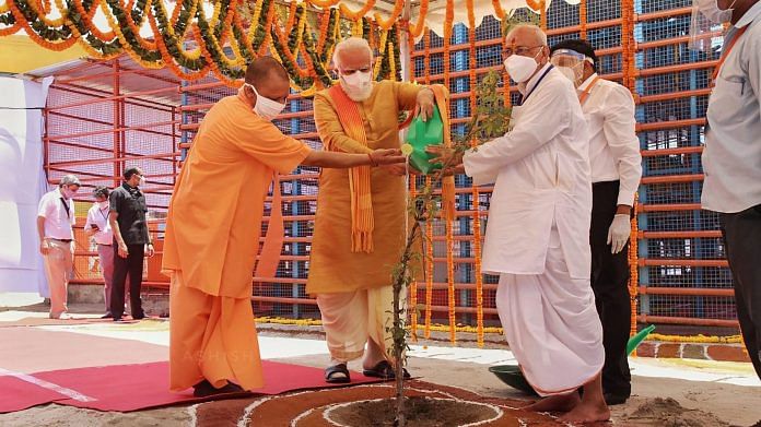 Prime Minister Narendra Modi along with Uttar Pradesh Chief Minister Yogi Adityanath waters Parijaat sapling ahead of the inception of Bhoomi Pujan for the construction of Ram Temple. | PTI