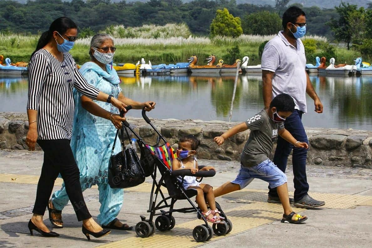 Some families were more conscientious about wearing masks as they enjoyed a stroll by the lake after months | Praveen Jain | ThePrint