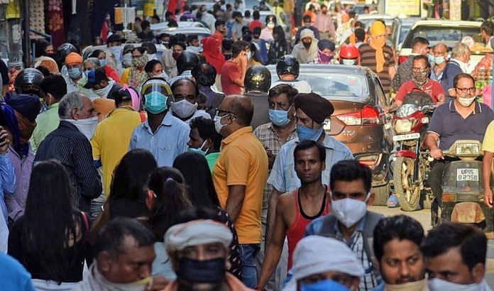 People flout social distancing norms as they gather in a weekly market in New Delhi | ANI