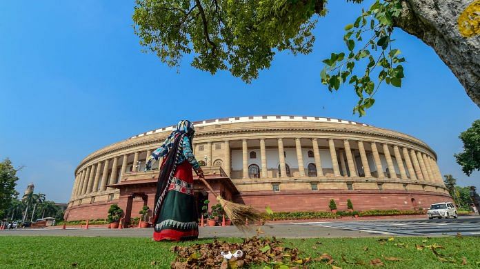 A civic worker sweeps a lawn in the premises of Parliament House during the ongoing Monsoon Session, in New Delhi, Tuesday, 15 September 2020 |PTI /Kamal Kishore