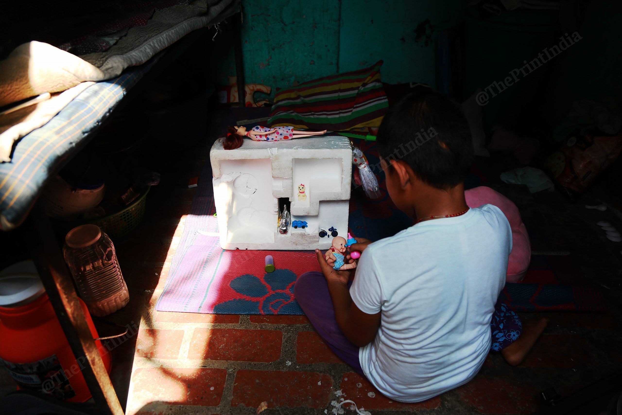 A sex worker's child plays with a dollhouse she has fashioned out of a thermocol box | Manisha Mondal | ThePrint