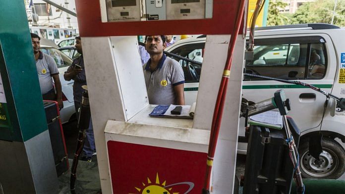 An employee refuels a vehicle with compressed natural gas (CNG) at an Indraprastha Gas Ltd. gas station in New Delhi | Photographer: Prashanth Vishwanathan | Bloomberg
