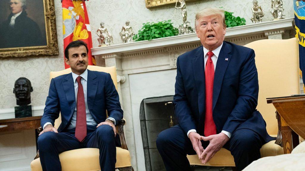 US President Donald Trump (R) speaks while Sheikh Tamim bin Hamad Al Thani, the Emir of Qatar, listens, during a meeting at the White House in 2019. | Photographer: Kevin Dietsch | Pool via Bloomberg