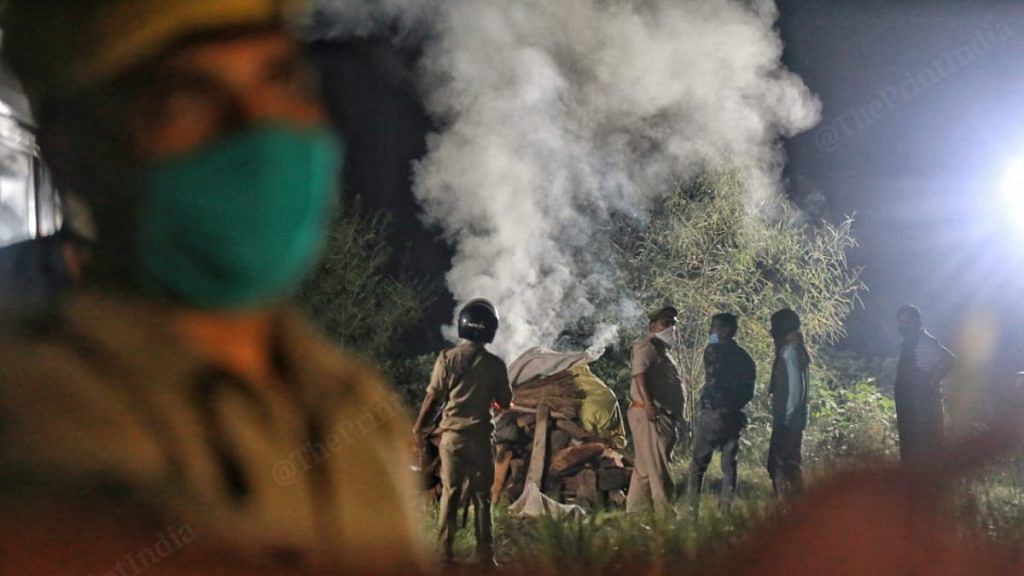 File photo of the Uttar Pradesh Police cremating the Hathras gangrape and murder victim in the middle of the night | Manisha Mondal | ThePrint