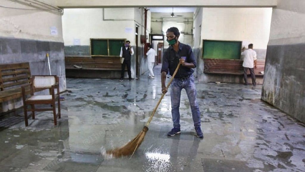Court staff members cleaning up the premises ahead of the Babri demolition verdict pronouncement in Lucknow Friday | Photo: Praveen Jain | ThePrint