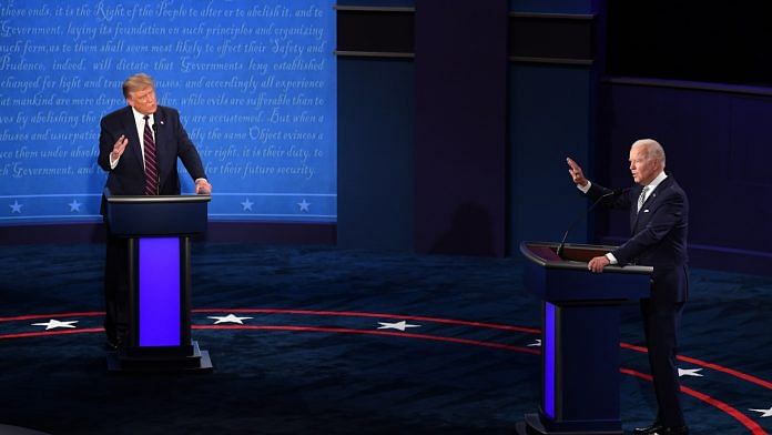 Democratic presidential nominee Joe Biden (R) and US President Donald Trump speak during the first US presidential debate in Cleveland, Ohio, on 29 September