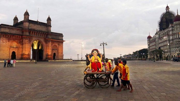A small group of men carry an idol of Lord Ganesh for visarjan (immersion) in the Arabian Sea near the Gateway of India in Mumbai's Colaba area Tuesday | Vasant Prabhu | ThePrint