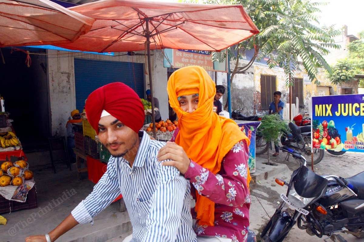 Young men on two-wheelers sometimes cover their face with dupattas, hoping to pass off as women to avoid being stopped by police | Praveen Jain | ThePrint