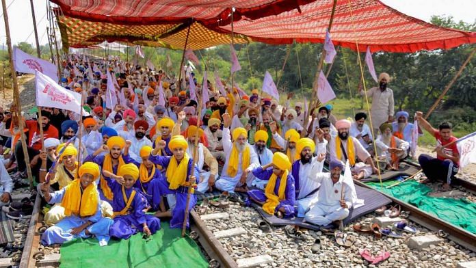 Amritsar: Locals join farmers in their ongoing Rail Roko or Stop the Trains agitation, against the central government over newly passed agri-bills, at Devi Dass Pura village, 20km from Amritsar, Monday, Sep. 28, 2020. (PTI Photo) (PTI28-09-2020 000145B)