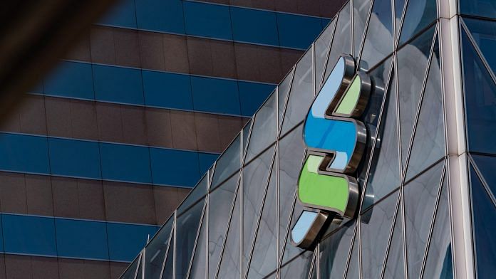 File photo of The Standard Chartered Plc logo is displayed atop the Standard Chartered Wealth Management Centre in Hong Kong