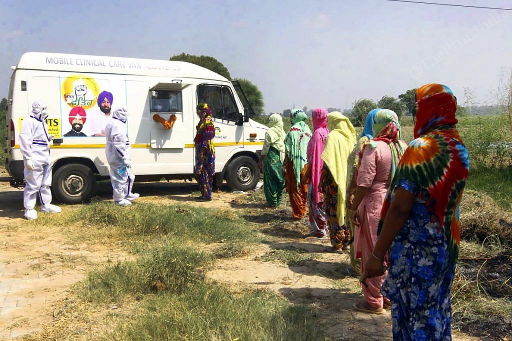 Female farmers queue up ahead of a mobile testing van as Punjab carries out a testing drive in rural areas | Praveen Jain | ThePrint
