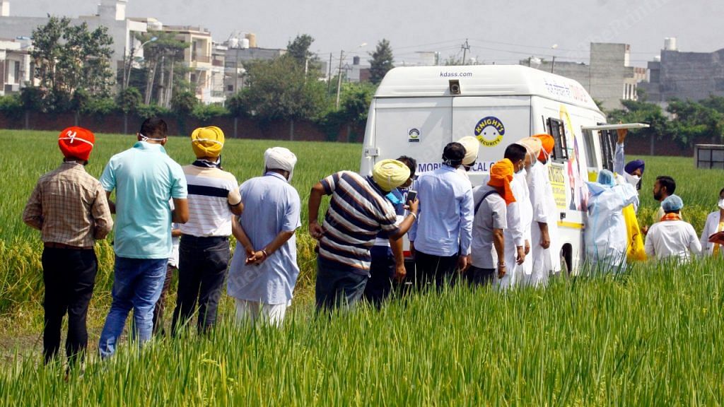Few locals gathered to get themselves tested for coronavirus as they saw a mobile testing van passing by in Sahnewal village near Ludhiana | Praveen Jain | ThePrint.