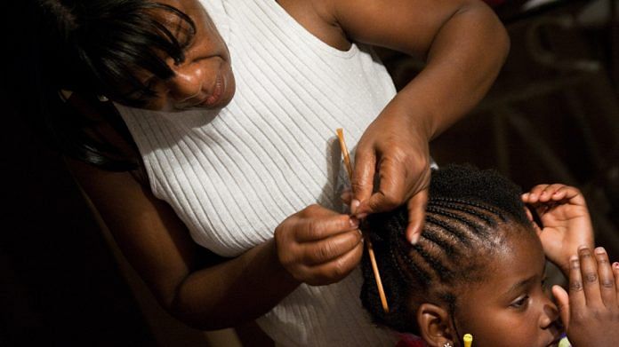 Representational Image | A woman styles the natural hair of an African American child | Commons