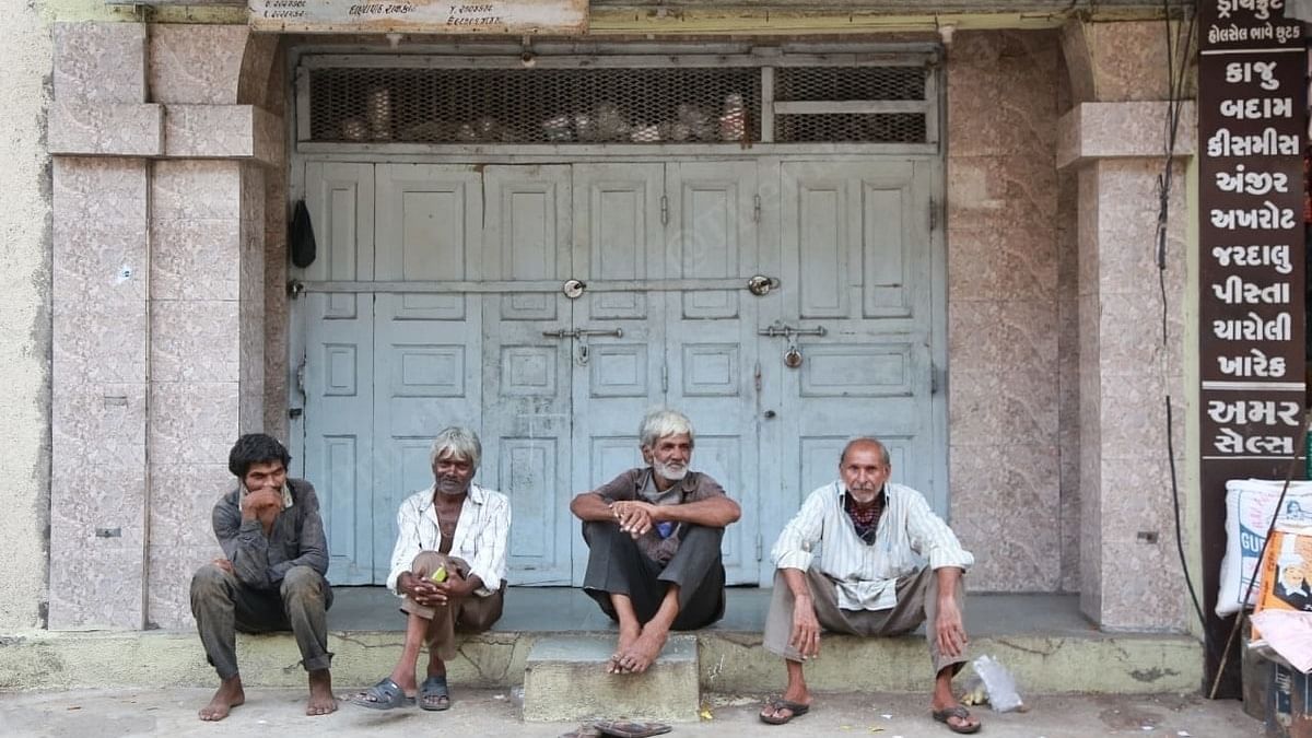 Workers sit without masks at a grocery market in Rajkot. | Photo: Manisha Mondal/ThePrint 