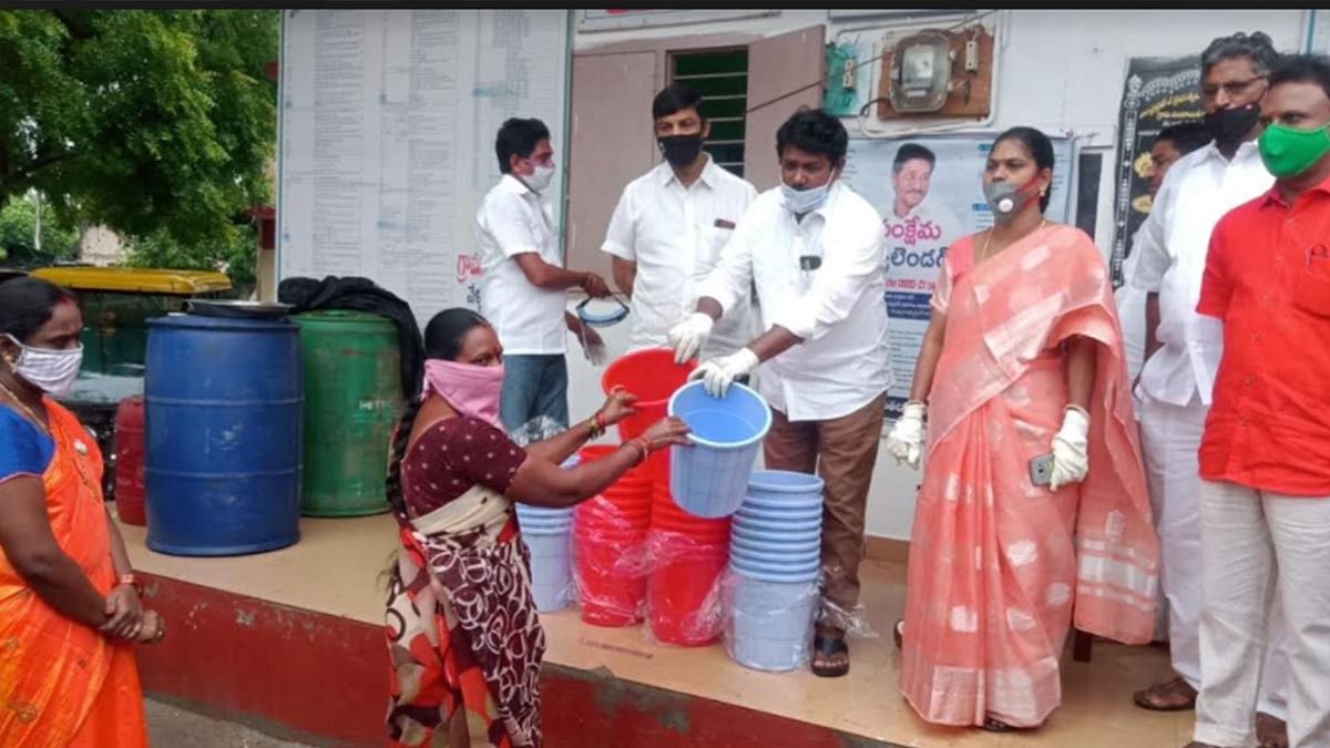 MLA Venkata Rao distributes bins to locals in Gopalapuram Mandal, West Godavari. | Photo: Special arrangement