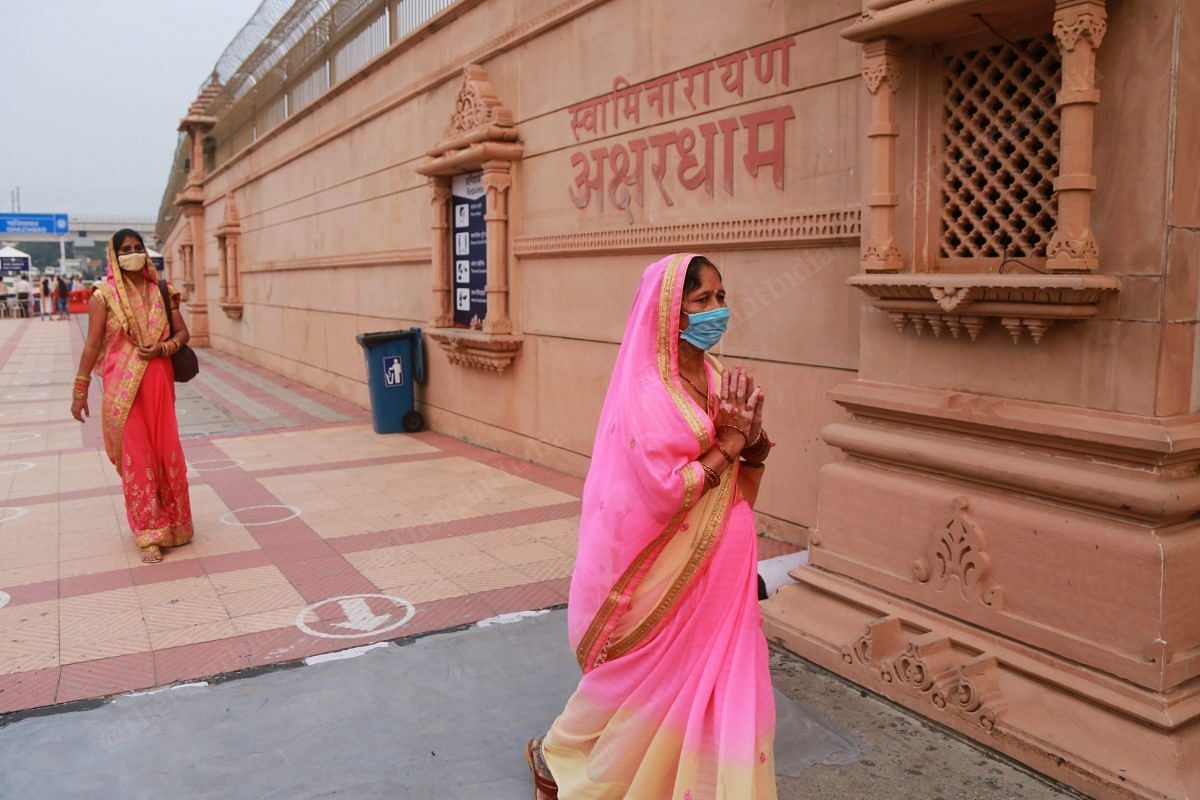 A woman chants while walking inside the temple | Photo: Manisha Mondal | ThePrint