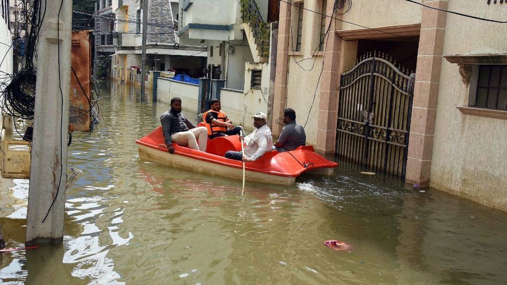 Residents of a flooded Hyderabad colony are evacuated with a boat after heavy rains in the Telangana capital this month | ANI