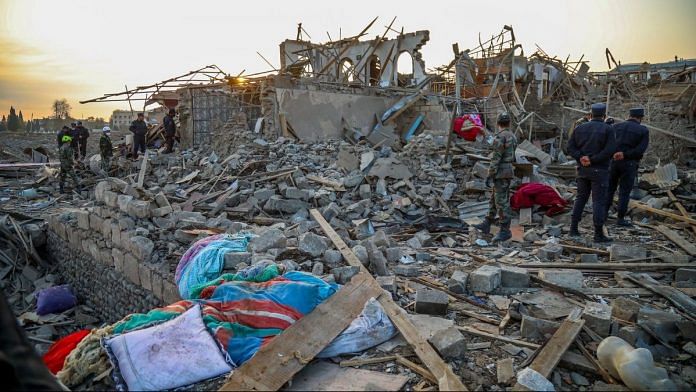 Search and rescue teams work on the blast site hit by a rocket during the fighting over the breakaway region of Nagorno-Karabakh on 17 October 2020 in Ganja, Azerbaijan | Photo by Aziz Karimov/Getty Images via Bloomberg