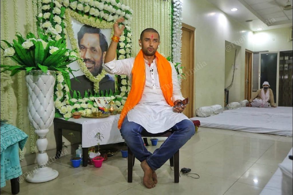 LJP president Chirag Paswan at his residence. A photo of his father Ram Vilas Paswan, who died earlier this month, is seen behind him | Praveen Jain | ThePrint