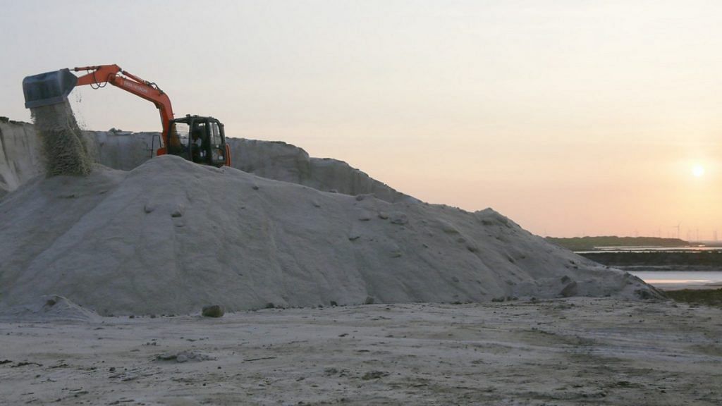 An excavator machine sifts salt in Maliya, Morbi, Gujarat | Photo: Manisha Mondal | ThePrint