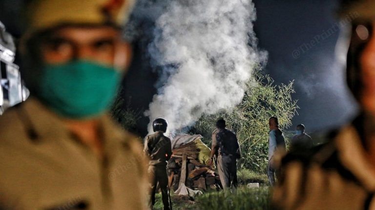 The victim's pyre burns amid heavy police presence in her village, Boolgarhi | Manisha Mondal | ThePrintIndia