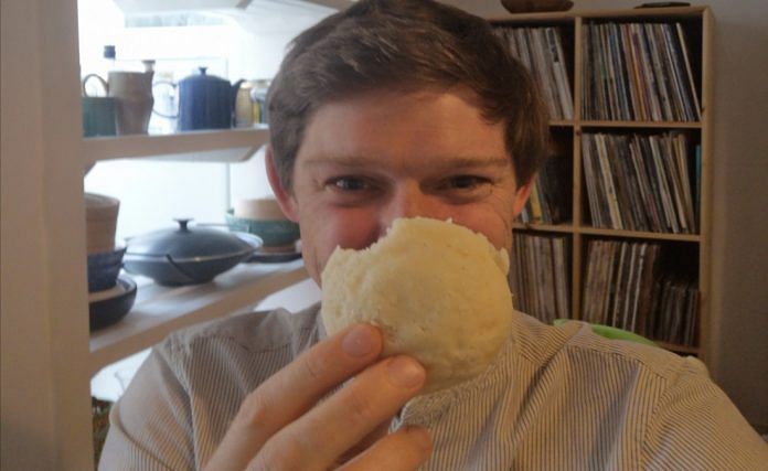 British lecturer Edward Anderson poses with an idli, in a photo he posted on his Twitter account | @edanderson101 | Twitter