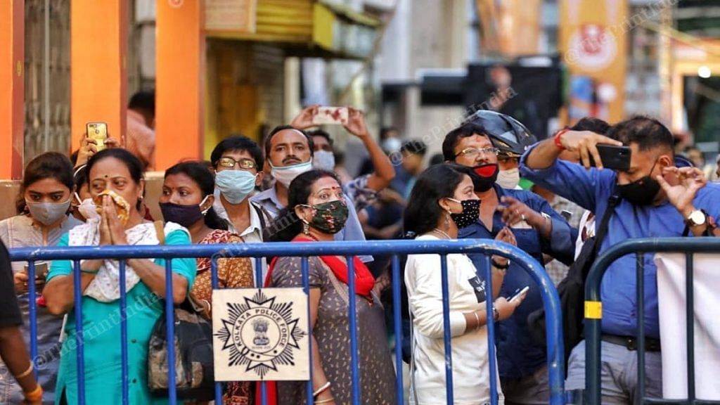 File photo of a crowd gathered outside a Durga Puja pandal in Kolkata. Kolkata is among cities which are showing a rise in number of active cases. | Manisha Mondal | ThePrint
