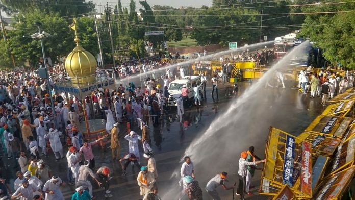 Police personnel use water cannons to disperse farmers during a massive protest against the new farm bills, in Sirsa district, Tuesday, Oct. 6, 2020 | PTI