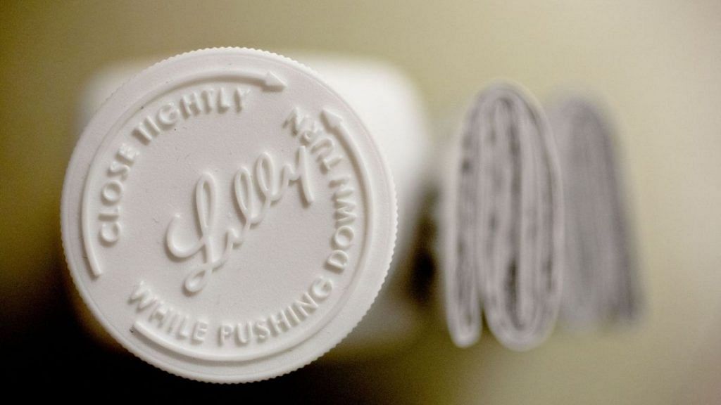 An Eli Lilly & Co. logo is seen on the cap of a pill bottle | Daniel Acker | Bloomberg