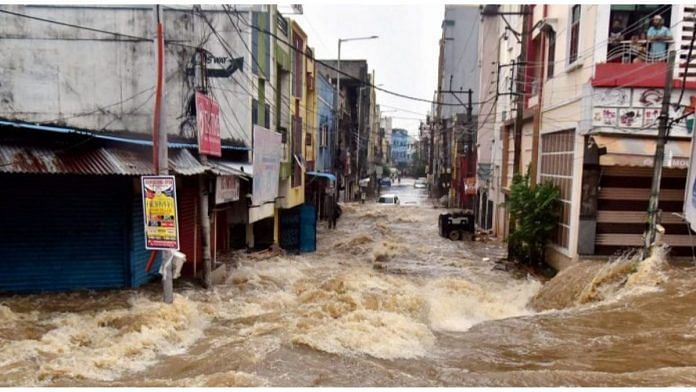 Floodwater gushes through a street following heavy rains, at Falaknuma, in Hyderabad, Wednesday, 14 October, 2020.| PTI