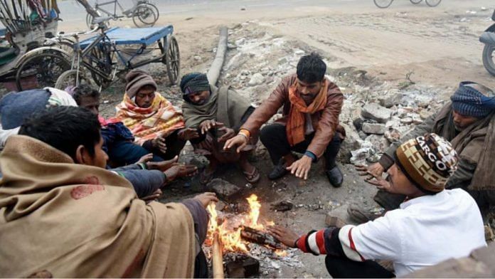 Men sitting by a fire | Representational image | ANI