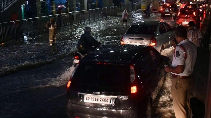 Vehicles wade through a flooded street in Hyderabad on Tuesday evening | ANI