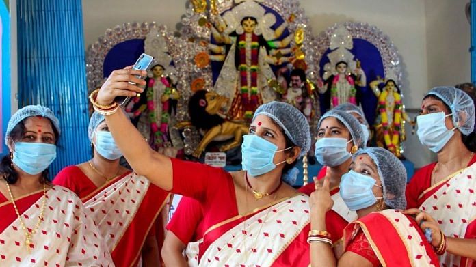 Representational image | Women take a selfie in front of the idol of Goddess Durga after West Bengal Chief Minister Mamata Banerjee virtually inaugurated their community Durga Puja in South Dinajpur district on 14 Oct 2020 | PTI