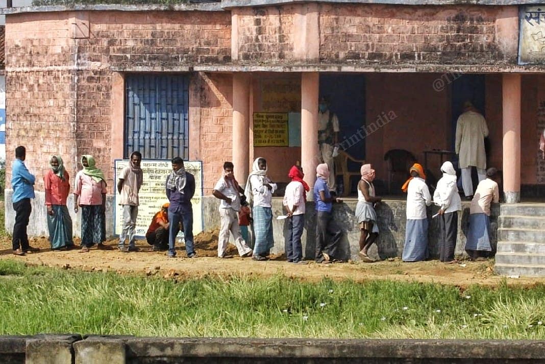 Villagers stand in line , waiting for their turn, to cast their votes in Sundarpur village | Praveen Jain | ThePrint