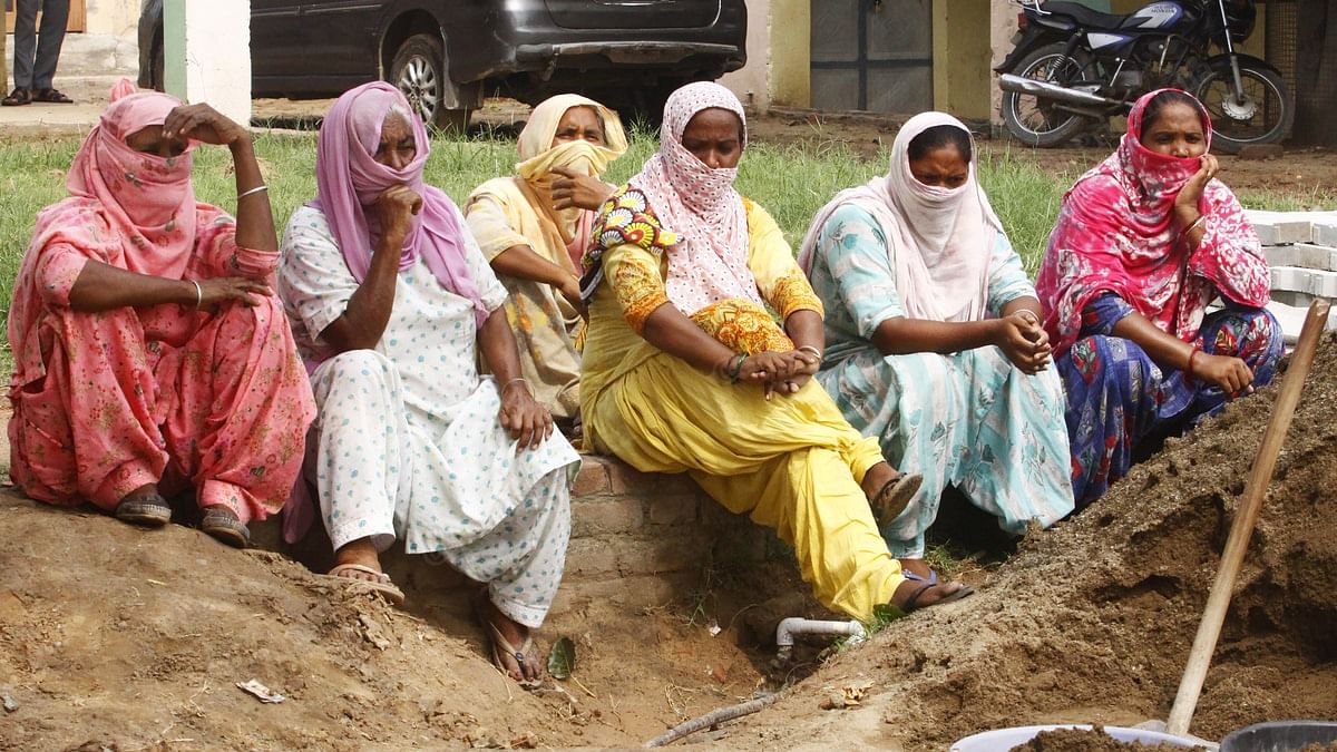 Kulwinder Kaur (in yellow) along with other women working at a construction site in Chunni Kalan Village, Punjab. | Photo: Praveen Jain/ThePrint