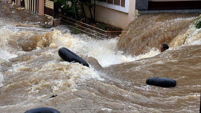 A man struggles to stay afloat in floodwater at Falaknuma, in Hyderabad on 14 October | PTI Photo